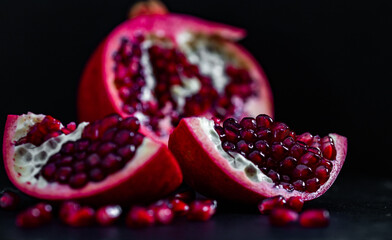 pomegranate pieces on black background