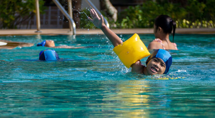 Boy practicing swimming in the pool