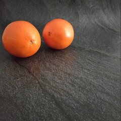 Oranges on a dark silver background