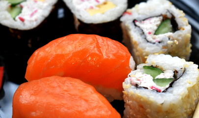 Japanese cuisine, nigiri sushi with salmon and rolls close-up