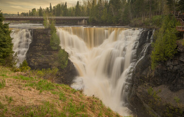 Obraz premium High falls waterfall on Minnesota and Canada Border. Sunset over beautiful Waterfall. 