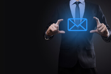 Businessman hand holding e-mail icon, Contact us by newsletter email and protect your personal...