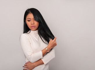 Beautiful young asian woman with long black hair wearing wrist watch