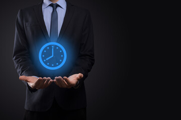 Businessman hand holds the icon of hours clock with arrow. Rapid execution of the work.Business...