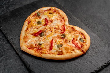 heart shaped pizza for valentine's day on stone background