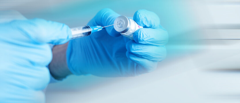 a doctor holding a syringe ready to give a vaccine injection