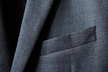 High resolution with details and quality shot of formal black or dark grey wool suit fabric...