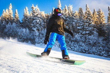 Snowboarder enjoying outdoors extreme sports on the Canadian slopes in Mont-Tremblant, Quebec,...
