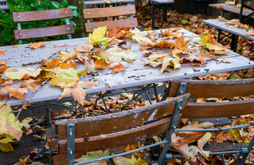 Herbstlaub auf Biergartentische