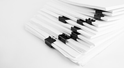 Stack of report paper documents for business desk. Business offices concept, soft focus.