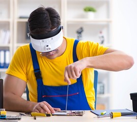 Computer repair technician repairing hardware