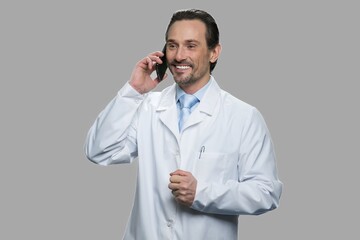 Happy doctor or scientist talking on cell phone. Male science engineer talking on mobile phone...
