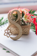 8 March,International Women's Day. Figure eight of wood with beautiful bouquet of flowers in a basket