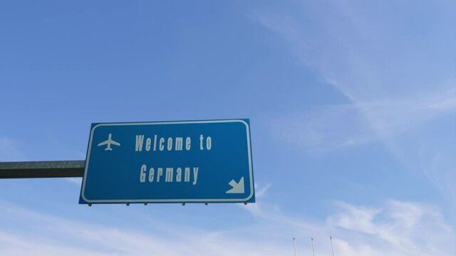 plane flying over welcome to germany  billboard road sign