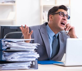 Desperate sad employee tired at his desk in call center