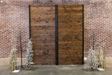 Decorative wood partition used as an empty backdrop for a Christmas winter holiday party with a red...