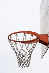 Basketball hoop, basket with white net and white blown up sky in background - obrazy, fototapety, plakaty