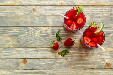 Strawberry iced lemonade drink with mint. Cold red coctail
