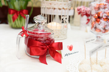 Jar with jelly beans on a candy bar at the wedding party