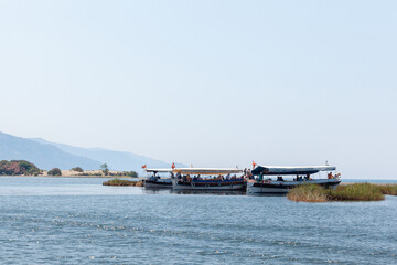 Tourist boats with Turkish flags on the background of mountains