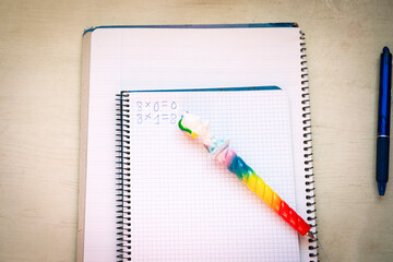 Back to school . A checkbook and a unicorn pen for a girl with elementary school math operations. Mathematics, logic, training