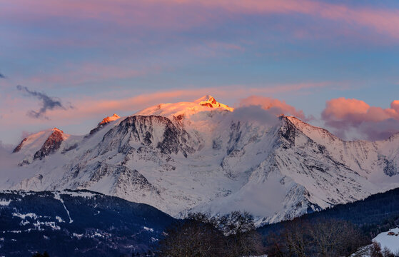 Warm morning clouds over Mont Blanc mountain ridge, the highest mountain in the Alps and Western Europe. Mont Blanc chain seen from the French side. Panorama shot.