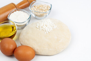 Fototapeta na wymiar Dough with flour, olive oil, eggs and rolling pin. cooking and baking ingredients 