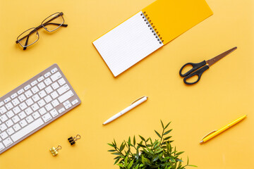 Workplace flat lay with computer and office supplies top view