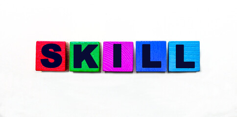 The word SKILL is written on colorful cubes on a light background
