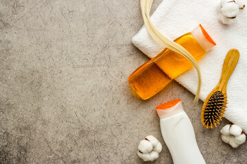 Herbal hair care and styling background with comb and shampoo. Top view