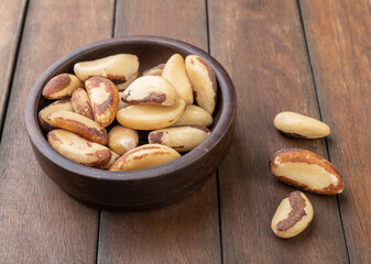 Brazil nuts on a bowl over wooden table