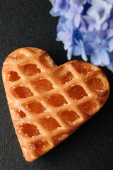 heart-shaped cake on the black table