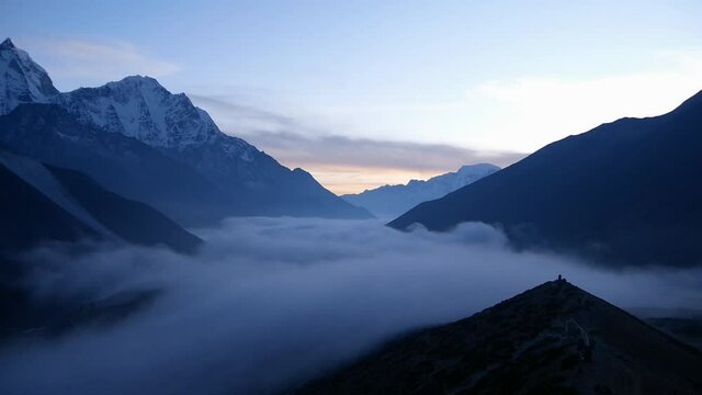 Panoramic view in time lapse of beautiful valley near Dingboche, Khumbu, Nepal in the Himalayas with majestic snow-capped mountains after sunset and clouds moving back in valley in cold evening air.