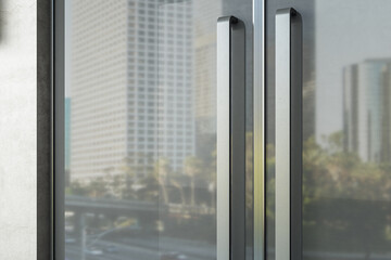 Fototapeta na wymiar Glass doors with kind of modern office building.