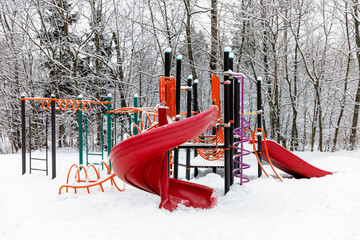 Children's playground in the winter forest. Activity and development.