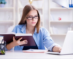 Young teenage female student preparing for exams at home