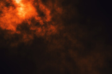 Fototapeta na wymiar Red glowing smoke on dark background.