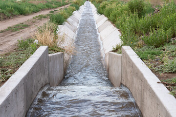 Fototapeta na wymiar Irrigation Ditch With A Flow Measurement Structure