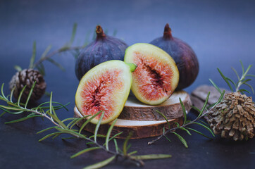 Fresh purple ripe figs on the table on a dark background. Top view. Flat lay.