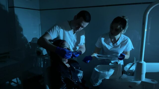 Woman mutant treats her terrible teeth in dental clinic.