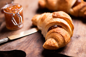 Fresh homemade croissants on wooden table