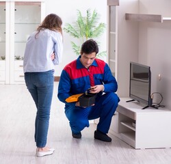 Tv repairman technician repairing tv at home