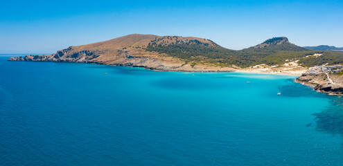 Fototapeta premium An aerial panorama of Cala Mesquida shoreline on Mallorca island in Mediterranean Sea