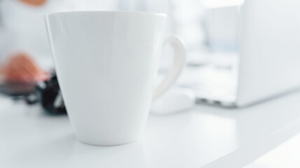 Close up view of young female freelancer that working indoors in the office at daytime
