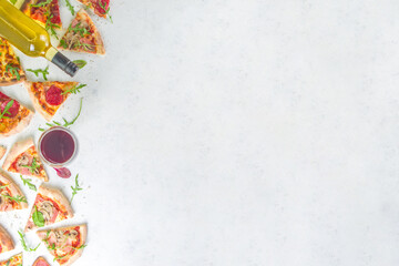 Pizza party concept.  Set of pizzas with various fillings, Pieces of different pizza, glass and bottle with wine. Flatlay top view copy space on white background