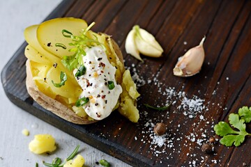 Boiled Potatoes in a peel in a bowl with spices, herbs, herbs. Lunch, the main side dish for dinner, with sour cream.