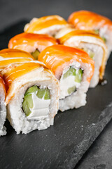 appetizing sushi roll philadelphia with eel cucumber and unagi on a black stone plate