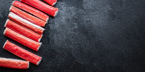 crab sticks seafood semi-finished fish mince ready to cook and eat on the table for healthy meal snack outdoor top view copy space for text food background rustic image diet pescetarian © Alesia Berlezova