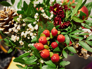 Christmas flower arrangement with red and mixed holiday greens