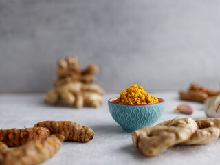 Bowl with garlic, ginger and turmeric paste with ingredients. Indian cuisine.